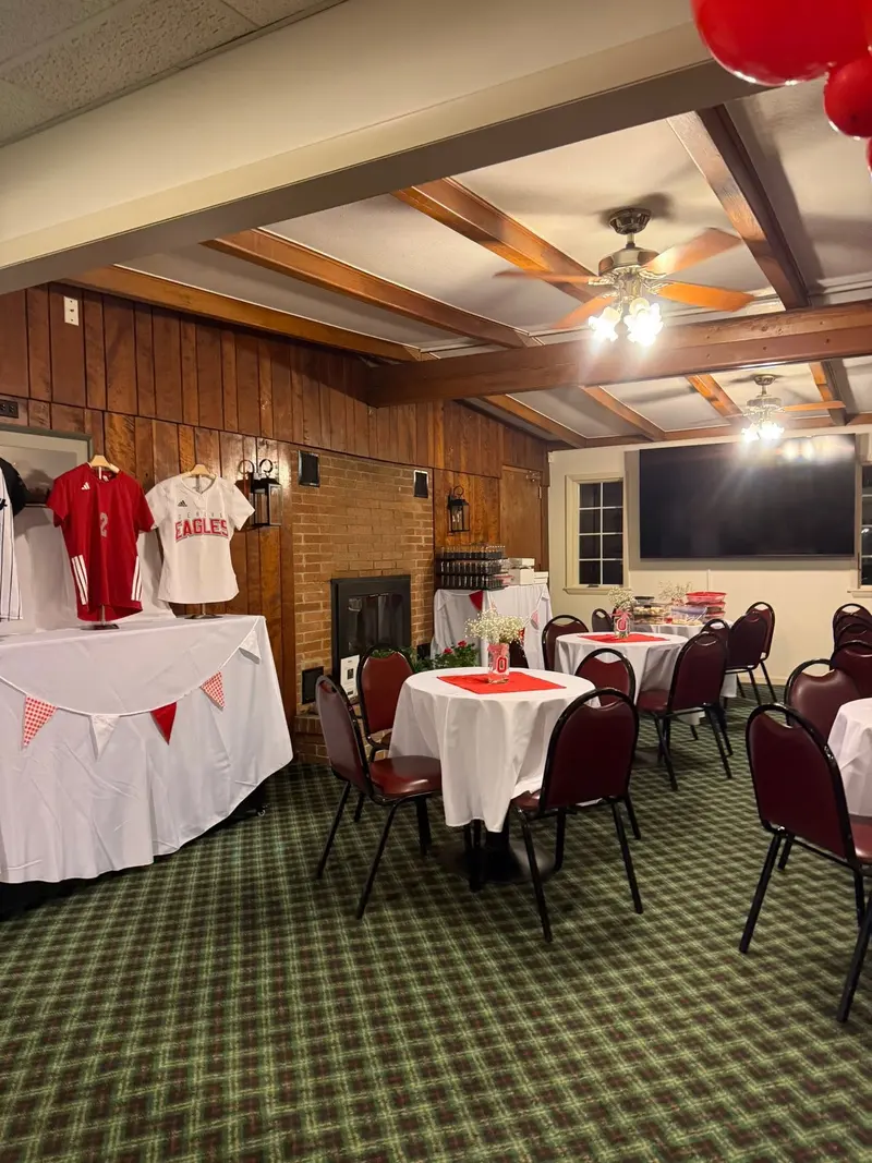 Warm wood beams and ceiling fans above the venue's fireside room